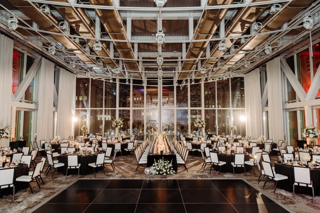 ballroom, dance floor, large windows, no curtains, all tables covered with black tablecloths, white chairs with a black outline, Orlando, FL