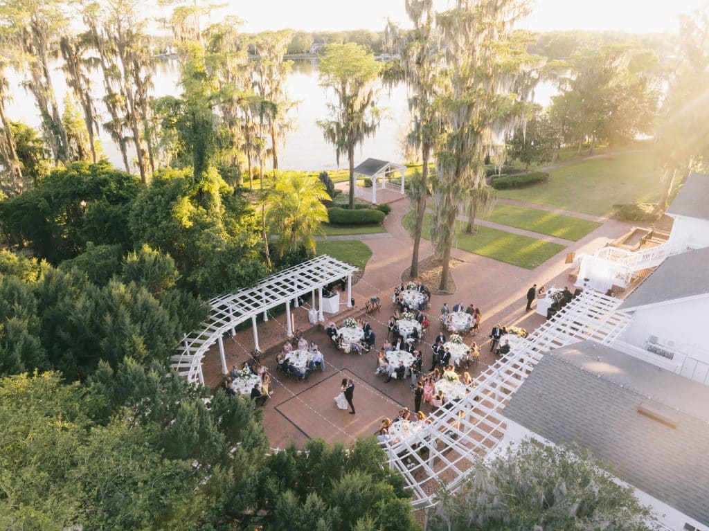 aerial view of the venue, cocktail hour, water view, tall trees, brick walkway, Melanie Paige Events + Design, Orlando, FL