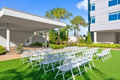view from the left of the wedding ceremony set up, view of the hotel on the right, bright sunny day, Orlando, FL