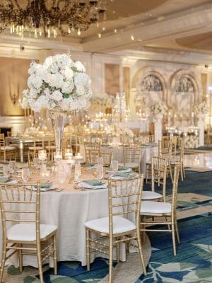 close up of a reception table, gold chairs with white cushions, tall centerpieces, ballroom, Ritz-Carlton Orlando Grande Lakes, Orlando, FL
