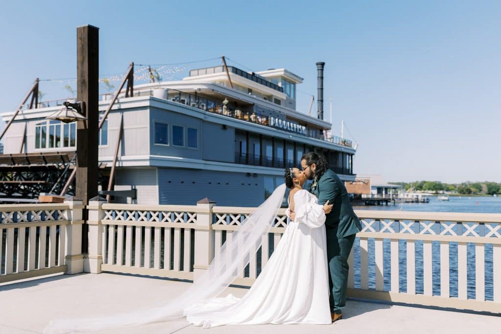 boat at the dock, wedding couple on the dock, kissing, Disney Springs, Paddlefish, Orlando, FL