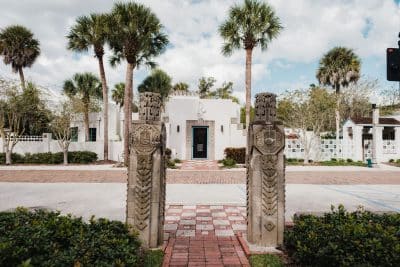 patio area, palm trees, brick walkway, white building, ornate columns, Orlando, FL