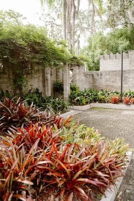 colorful plants on display in the garden and patio area, stone walls, stone patio, trees, Orlando, FL