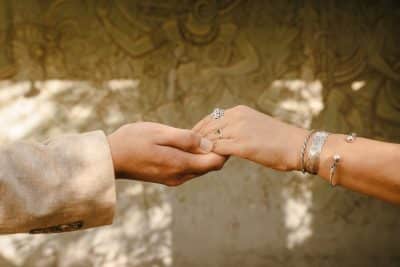 bride and groom holding hands, bride wearing bracelets and her rings, Orlando, FL