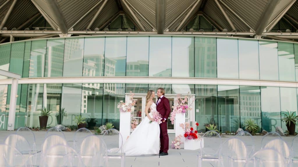 bride and groom standing outside the entrance to the Dr. Phillips Center, Orlando, FL