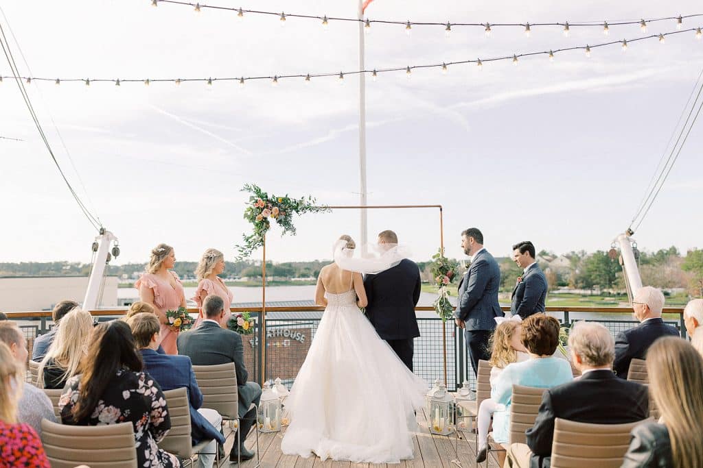 wedding couple at their ceremony, on deck of the Paddlefish boat, Orlando, FL