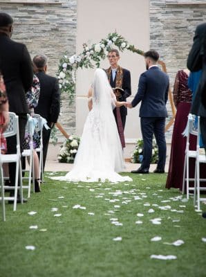 bride and groom holding hands at the altar during their wedding ceremony, The Celeste Hotel, Orlando, FL