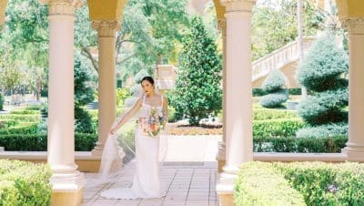 bride in her wedding gown and holding her bouquet, patio area, Ritz-Carlton Orlando Grande Lakes, Orlando, FL