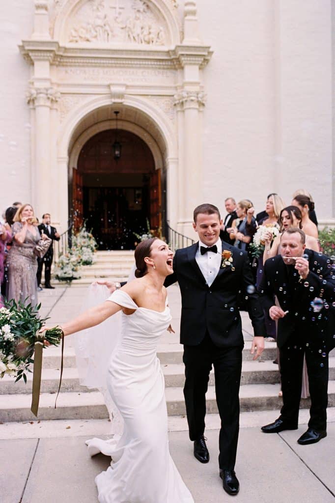 bride and groom leaving the church, guests cheering them on, Orlando, FL