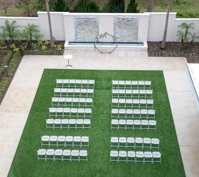 aerial view of the wedding ceremony set up, white chairs, turf grass, Orlando, FL