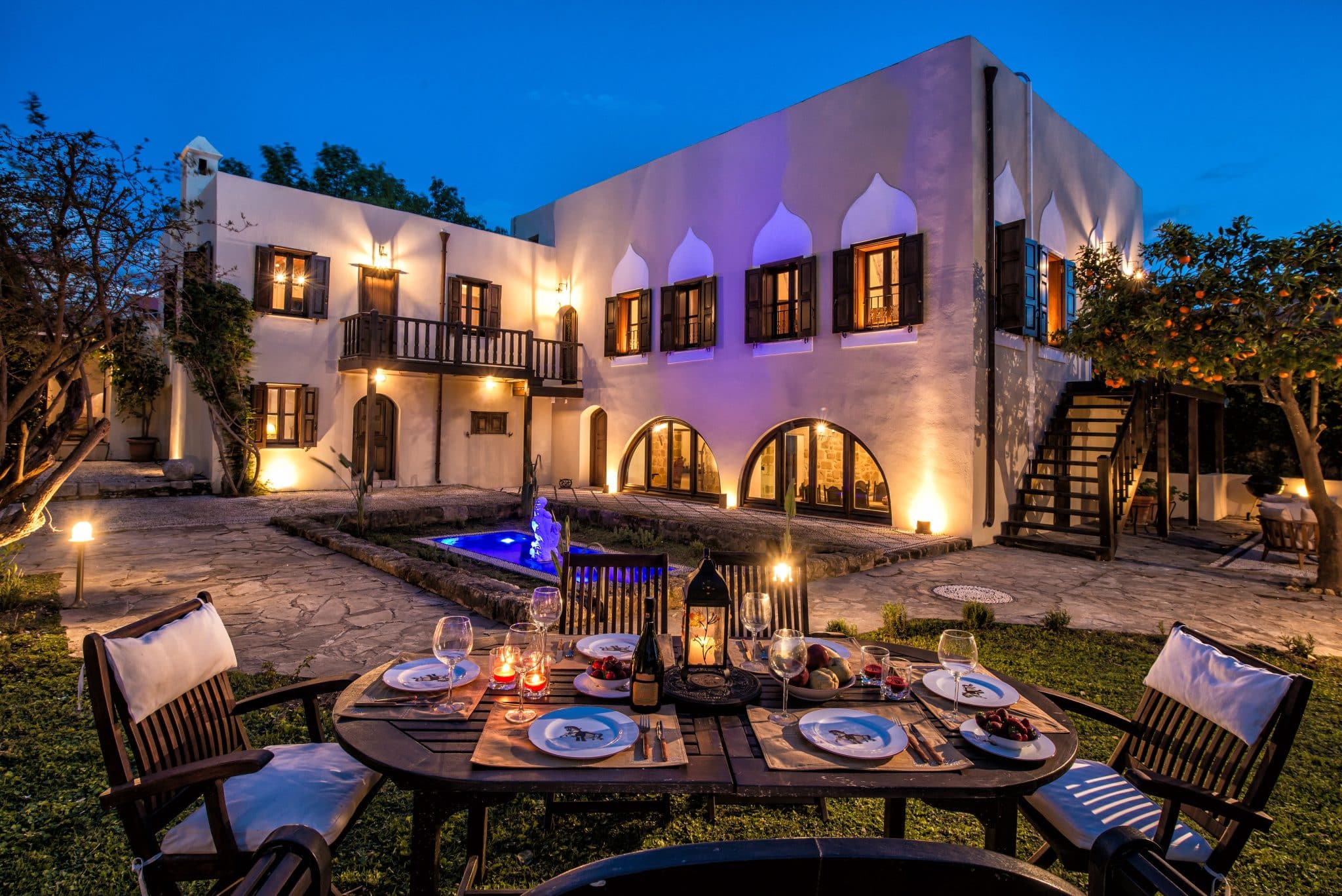 Outdoor wedding venue in greece for at night with uplighting on the building