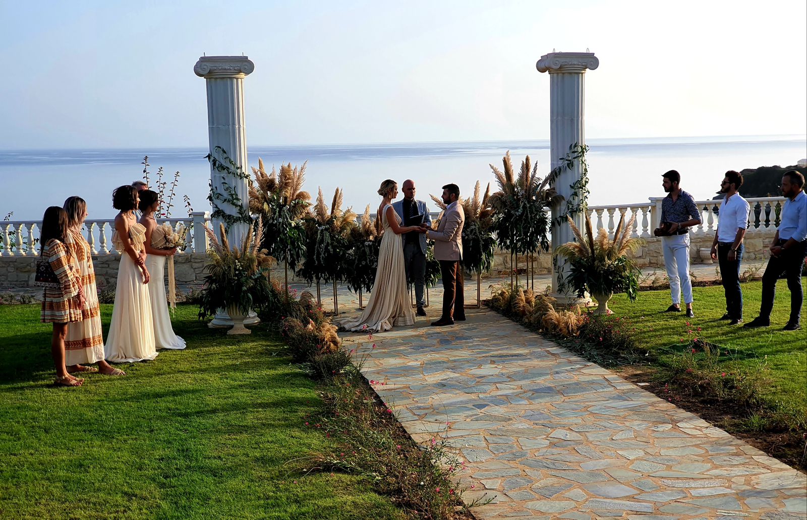 Destination Wedding in Greece at wine dark seas overlooking the ocean with column arches