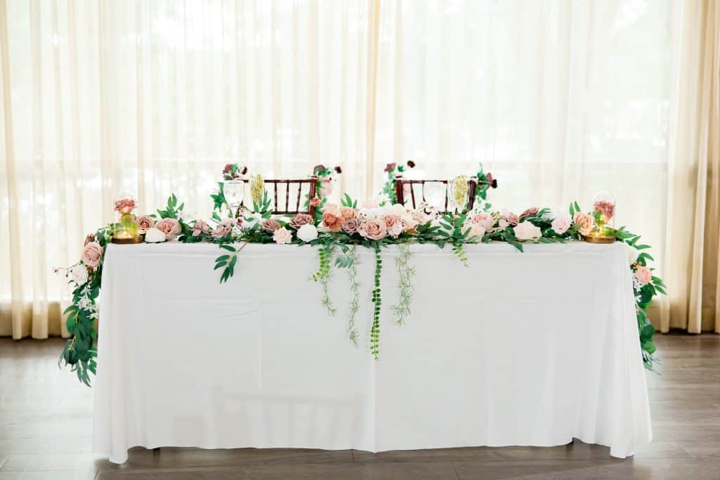 head table, white tablecloth, pink floral arrangement the length of the table, Falcon's Fire Golf Club, Orlando, FL