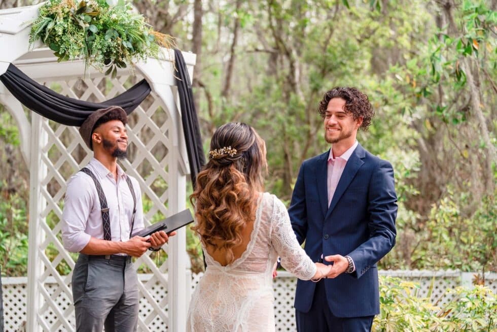 bride and groom holding hand, officiant executing the wedding ceremony, Orlando, FL