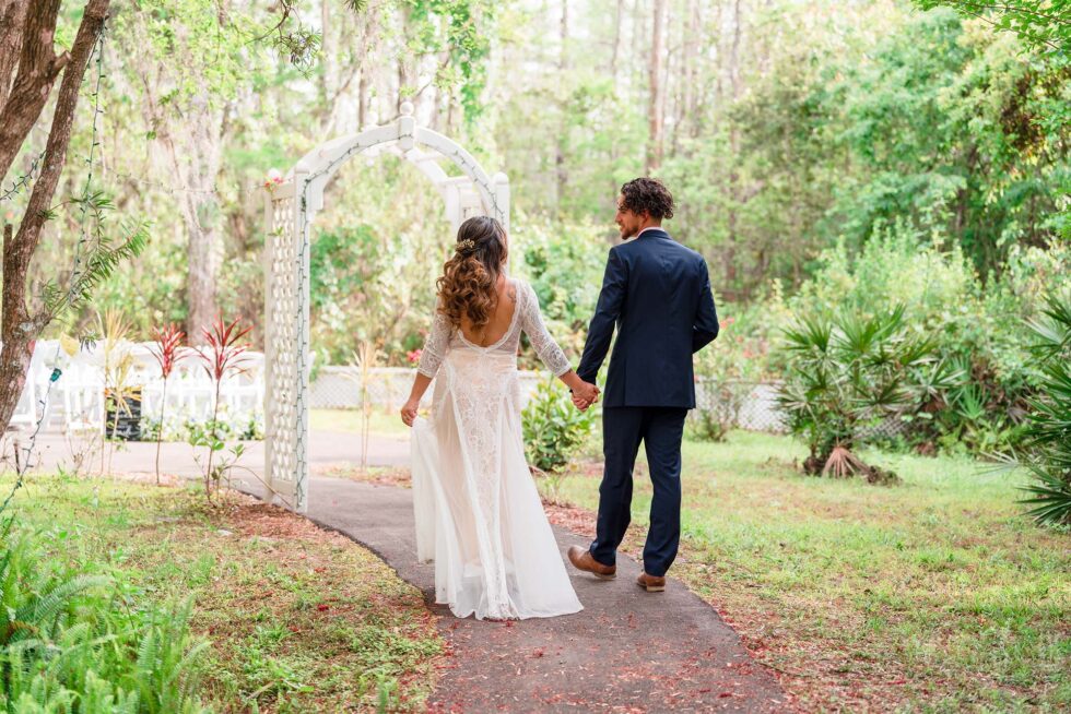 man and woman walking towards their wedding ceremony set up on their wedding day, Little Paradise Wedding Venue, Orlando, FL