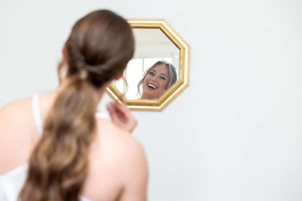bride getting ready at the highland manor for the burgundy and navy wedding