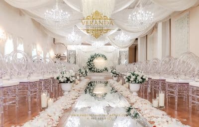 wedding ceremony, clear chairs, white florals all around the room, Orlando, FL