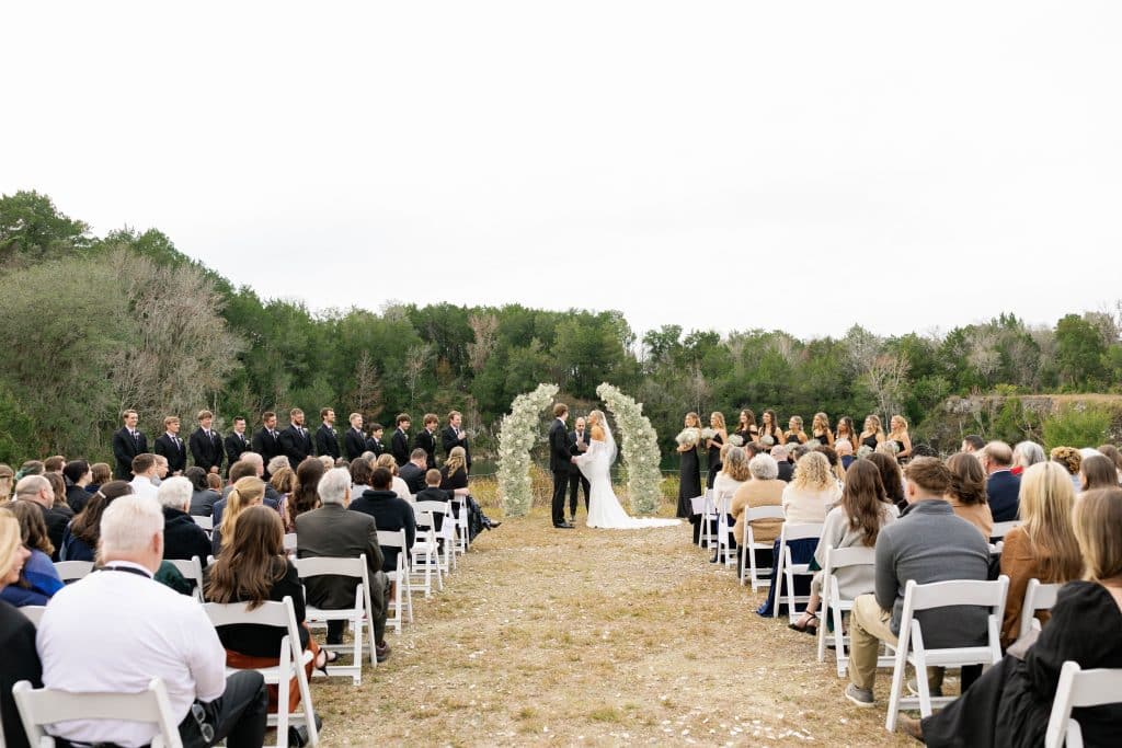 bride and groom at the altar, wedding guests watching the ceremony, outdoors, Orlando, FL