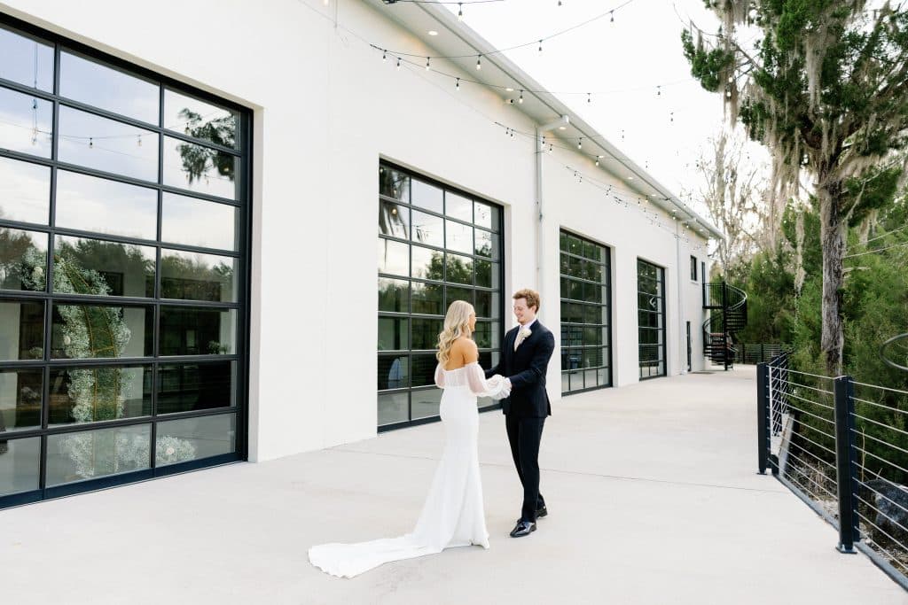 bride and groom holding hands, outside the venue, Orlando, FL