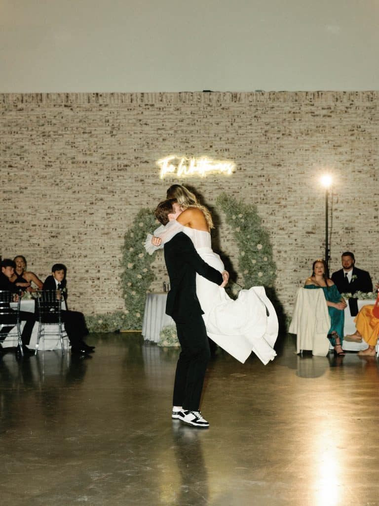 groom lifting his bride on the dance floor, wedding reception, Orlando, FL