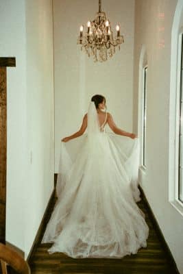 bride standing in the hallway in her gown, her veil and train behind her, Orlando, FL