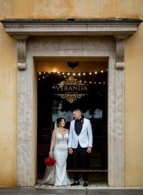 bride and groom standing in the large open doorway, string lights inside, Orlando, FL