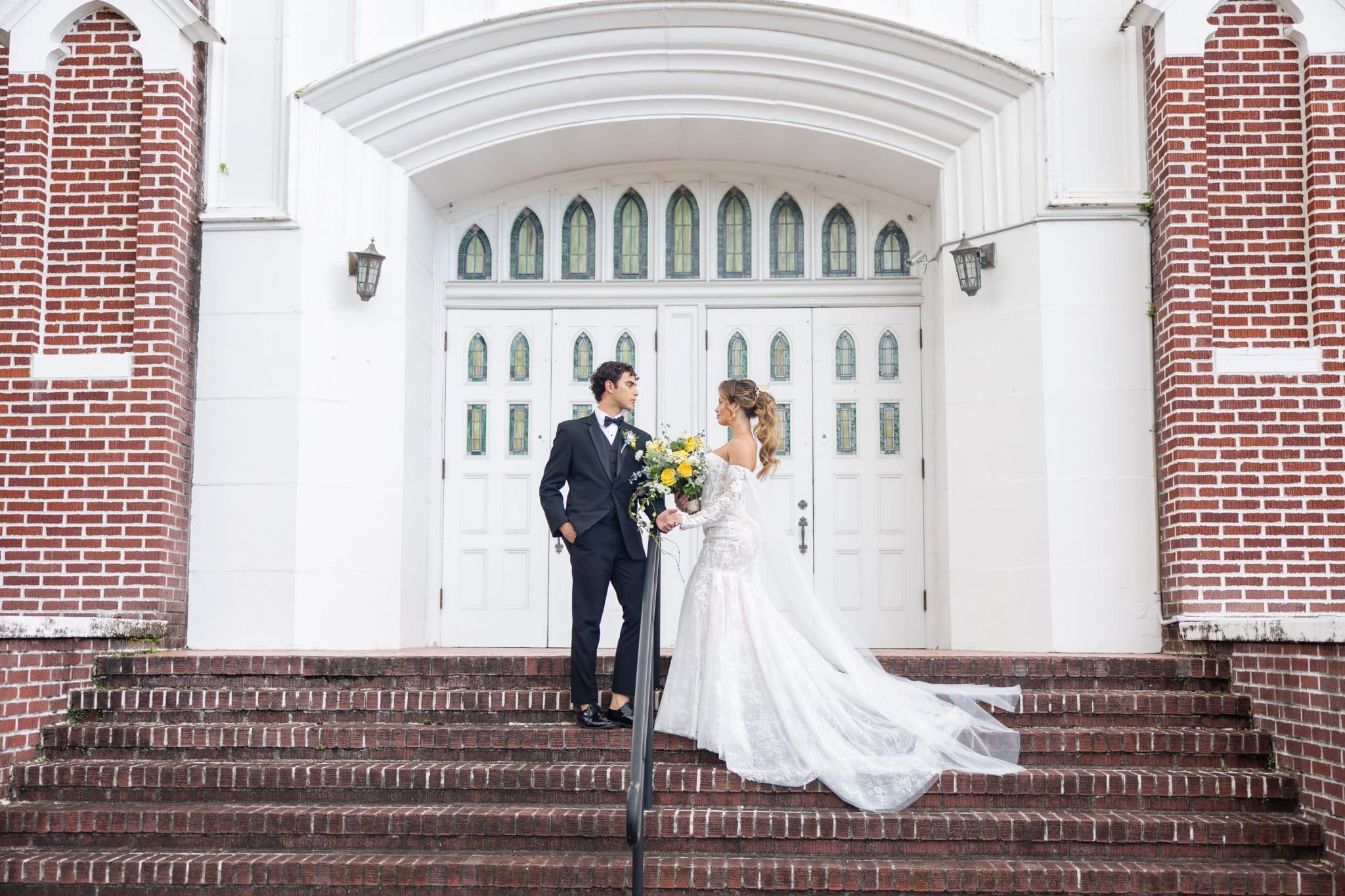 bride and groom standing in front of venue for their italian summer wedding