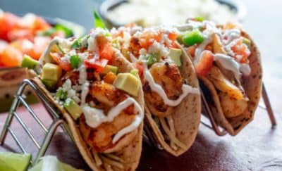 street tacos on a taco stand, topped with cream, shrimp and cojita cheese, Orlando, FL