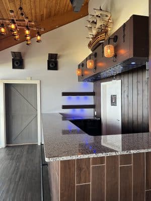 bar area at Sanford Galleon, granite countertop, grey barn door, wood paneling on the ceiling, Orlando, FL