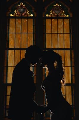 man and woman kissing in front of the window, dark lighting, Northwest Square Events, Orlando, FL
