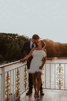 bride and groom kissing onboard the Barbara Lee boat, sunset, Orlando, FL