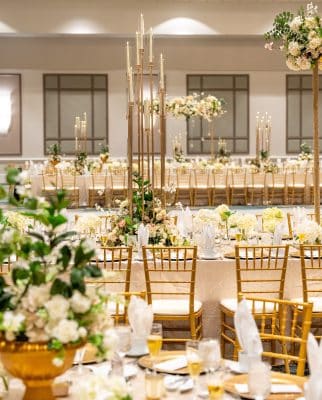 tablescape of gold chargers, gold tablecloth, white and green florals, gold chairs, Rosen Centre, Orlando, FL