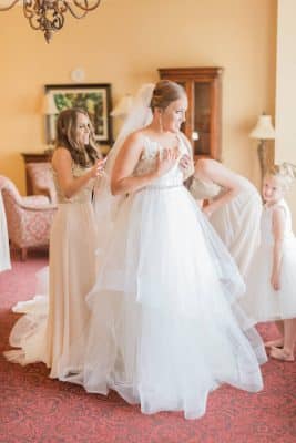 bride getting ready for her wedding, her bridesmaids assisting her, bridal suite, Rosen Shingle Creek, Orlando, FL