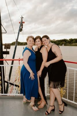 wedding guests posing for a photo on the deck of the boat, St. Johns Rivership Co., Orlando, FL