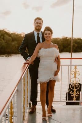 newly married couple on the deck of the boat, posing for a photo, sunset, Orlando, FL