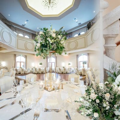 beautiful floral centerpiece in the center of the table, close up of a tablscape, white tablecloth, Orlando, FL