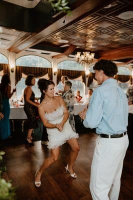 bride in her white dress dancing on the dance floor with other guests around her, Orlando, FL