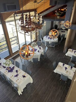 aerial view of the dining room, white tablecloth, large sliding doors, chandelier, Sanford Galleon, Orlando, FL