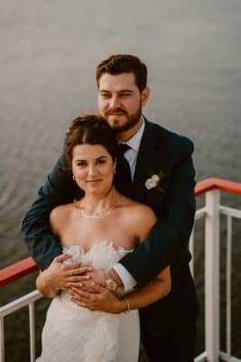 bride and groom embracing onboard, near the bow of the boat, St. Johns Rivership Co., Orlando, FL