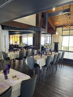 long table facing the stage in the dining room, tall ceilings, large sliding doors onto the patio, Sanford Galleon, Orlando, FL