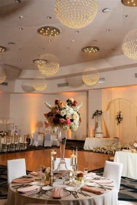 reception table, chairs covered with white chair covers, large floral centerpiece, dance floor, table with the wedding cake, Renaissance Orlando Resort and Spa, Orlando, FL