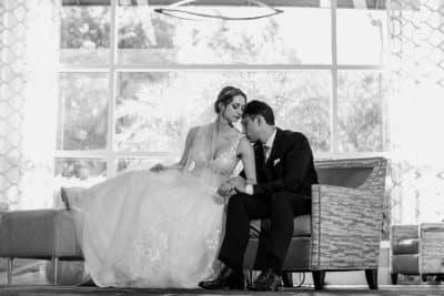 black and white photo, bride and groom on sofa in the hotel, embracing each other, Rosen Centre, Orlando, FL
