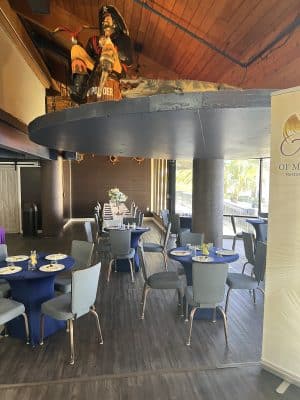 side view of the dining room, set with small cocktail tables, blue table covers, Orlando, FL