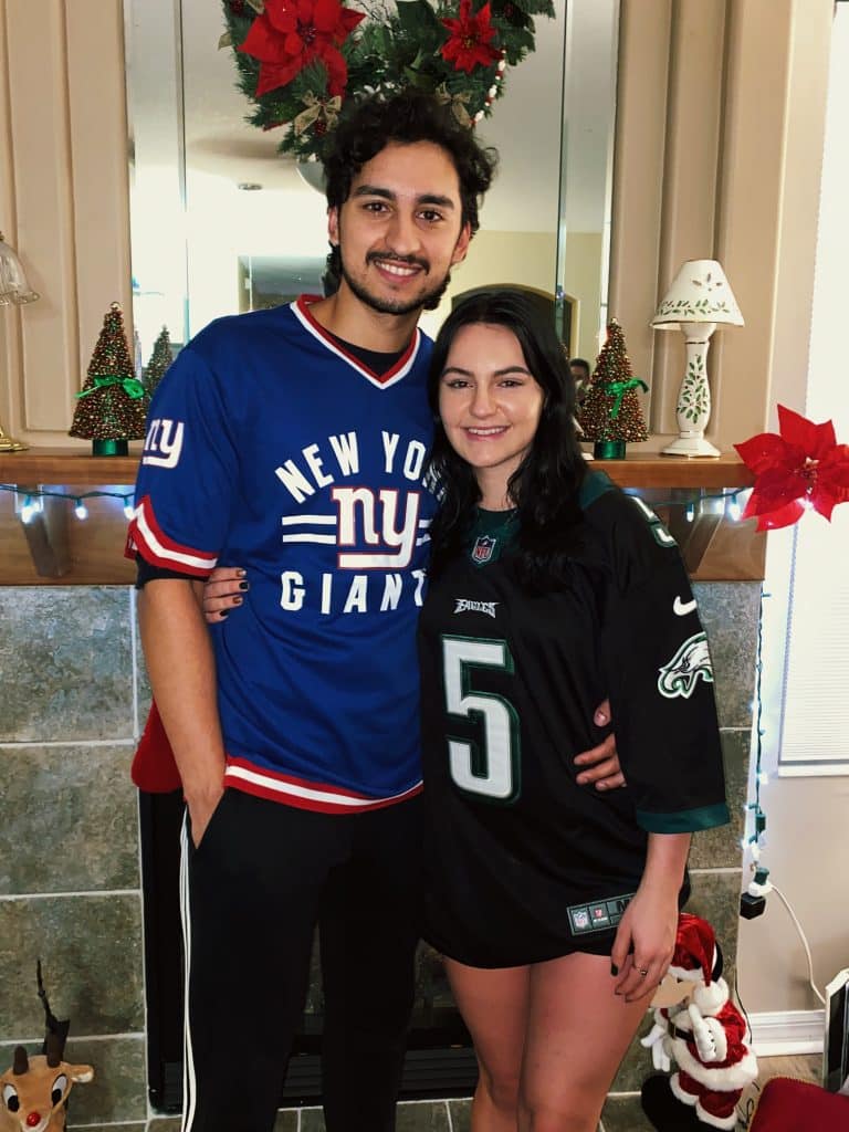 couple with jerseys on smiling