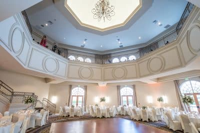 ballroom set for a wedding reception, two floors, hard wood floors, white tablecloths, Orlando, FL