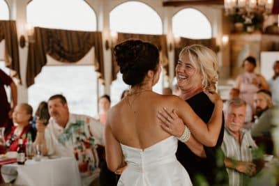 bride embracing her mother at the wedding reception, inside the boat, St. Johns Rivership Co., Orlando, FL