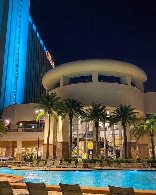 outdoor view of the hotel pool and patio area, lit up at night, Orlando, FL