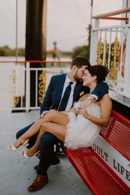 bride and groom cuddling on a bench on board the Barbara Lee boat, St. Johns Rivership Co., Orlando, FL