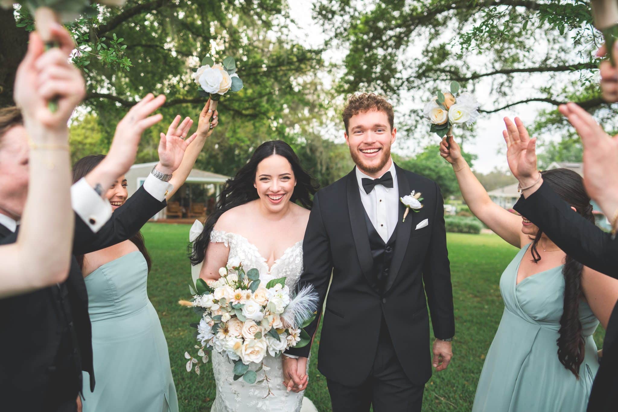 Bride and Groom walking in the middle of their friends