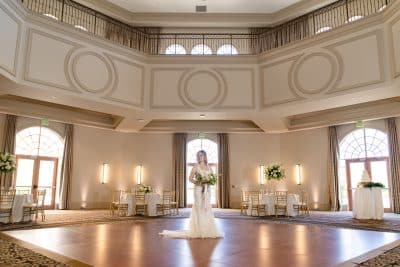 Rosen Shingle Creek, hotel and wedding venue, indoor venue event space, bride standing in her wedding gown with her bouquet on the dance floor, ballroom, Orlando, FL